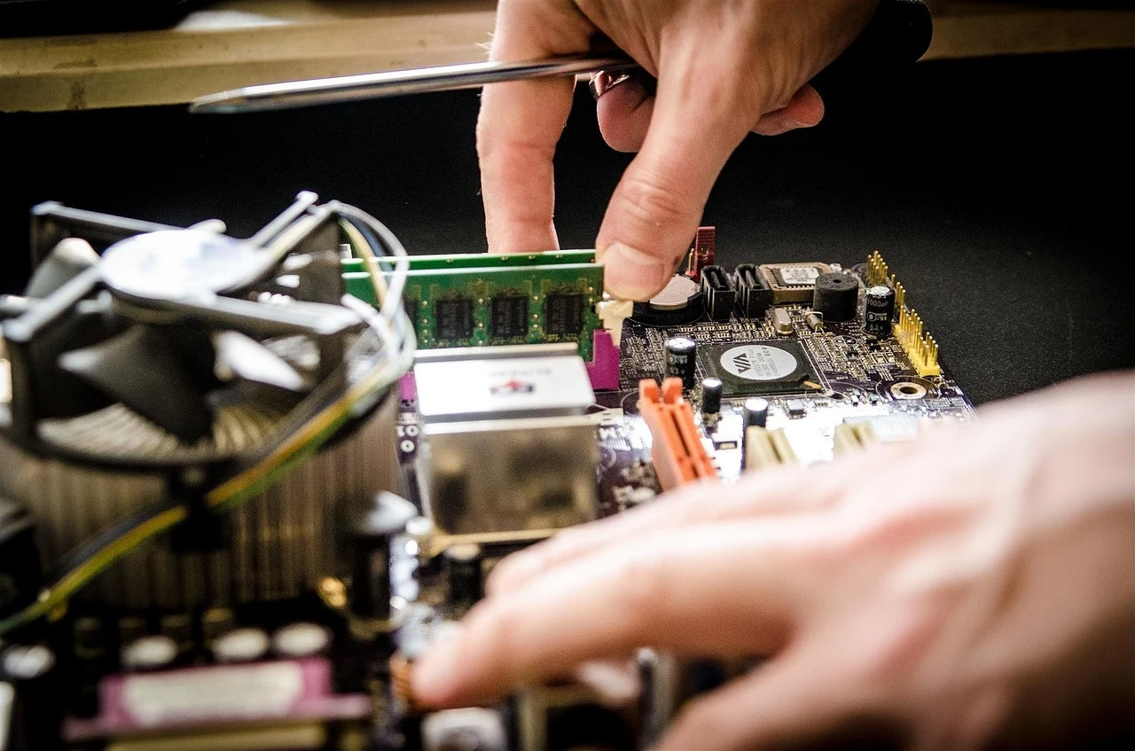 Hands carefully installing hardware inside a computer